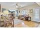 Cozy living room with hardwood floors, a ceiling fan, comfortable seating, and natural light creating a relaxing atmosphere at 103 Trimley Ct, Goose Creek, SC 29445