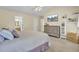 View of a large main bedroom featuring a bed, tv, dresser, shelves, and an entrance to the main bathroom at 103 Trimley Ct, Goose Creek, SC 29445