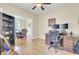 Office space with wood floors, natural light, built-in shelving, desk, and an open doorway to the dining room at 103 Trimley Ct, Goose Creek, SC 29445