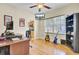 Home office setup with hardwood floors, guitars, and access to the kitchen at 103 Trimley Ct, Goose Creek, SC 29445