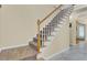 View of carpeted staircase featuring a wood handrail and white balusters leading to the upper level of the home at 103 Trimley Ct, Goose Creek, SC 29445