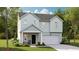Charming two-story home with light blue siding, a covered porch, and a two-car garage at 106 Lefton Lndg, Summerville, SC 29485
