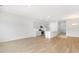 Open-concept living room with hardwood floors and ample natural light, flowing into the kitchen area at 107 Lefton Lndg, Summerville, SC 29485