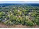 Aerial view of a residential neighborhood surrounded by lush greenery and trees near the waterfront at 1102 N Shadow Dr, Mount Pleasant, SC 29464