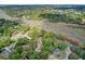 Aerial view of a waterfront neighborhood with houses nestled among mature trees and connected by waterways at 1102 N Shadow Dr, Mount Pleasant, SC 29464