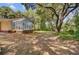 Expansive backyard featuring a sunroom extension and mature trees offering ample shade at 1102 N Shadow Dr, Mount Pleasant, SC 29464