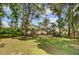 Beautiful backyard view with mature trees and a partial view of a marsh, offering a serene setting at 1102 N Shadow Dr, Mount Pleasant, SC 29464