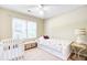 Bright bedroom featuring a twin bed, crib, and window with natural light at 1102 N Shadow Dr, Mount Pleasant, SC 29464