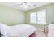 Cozy bedroom with neutral walls, large window, and a white ceiling fan at 1102 N Shadow Dr, Mount Pleasant, SC 29464