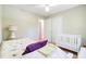 Cozy bedroom featuring a crib, a ceiling fan, and natural light from a nearby doorway at 1102 N Shadow Dr, Mount Pleasant, SC 29464