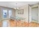 Bright dining room featuring wood floors, a glass table, transparent chairs, and french doors at 1102 N Shadow Dr, Mount Pleasant, SC 29464