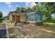 Back exterior view of home featuring brickwork and a large sunroom at 1102 N Shadow Dr, Mount Pleasant, SC 29464