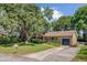 Classic brick home with a cozy front porch, an attached garage, and established landscaping at 1102 N Shadow Dr, Mount Pleasant, SC 29464