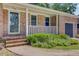 Close up of covered front porch with brick columns and green landscaping at 1102 N Shadow Dr, Mount Pleasant, SC 29464