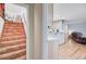 View of hallway with a staircase on the left and open kitchen with bar to the right at 1102 N Shadow Dr, Mount Pleasant, SC 29464