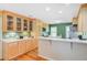 Bright kitchen with wood cabinets, quartz countertops, stainless appliances, and eat in bar at 1102 N Shadow Dr, Mount Pleasant, SC 29464