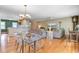 Open concept living area featuring wood floors, with kitchen access and large television at 1102 N Shadow Dr, Mount Pleasant, SC 29464