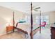 Main bedroom boasts large windows, carpet floors, a four-poster bed, and a ceiling fan at 1102 N Shadow Dr, Mount Pleasant, SC 29464