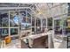 Bright sunroom with tile flooring, lots of windows, a ceiling fan and comfortable wicker furniture at 1102 N Shadow Dr, Mount Pleasant, SC 29464