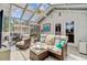 Bright sunroom with tile flooring, lots of windows, a ceiling fan and comfortable wicker furniture at 1102 N Shadow Dr, Mount Pleasant, SC 29464