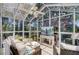 Bright sunroom featuring lots of windows, tile flooring, comfortable furniture and a ceiling fan at 1102 N Shadow Dr, Mount Pleasant, SC 29464