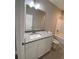 Modern bathroom with a granite countertop vanity and a bright lighting fixture at 110A Dukes St, Saint George, SC 29477
