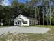 Picture of a charming new construction home with a white exterior and gravel driveway at 110A Dukes St, Saint George, SC 29477