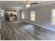 Open-concept living space with wood-look floors and views of the kitchen with stainless steel appliances at 110A Dukes St, Saint George, SC 29477