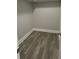 Hardwood floored walk-in closet with grey colored walls at 110A Dukes St, Saint George, SC 29477