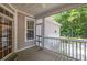 Charming screened-in porch with wooden floors and railing, offering a peaceful outdoor retreat with a view to the yard at 1116 Sea Island Crossing Ln, Mount Pleasant, SC 29464