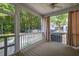 Cozy screened-in porch with ceiling fan, curtains, and view of backyard and plenty of space to enjoy the weather at 1116 Sea Island Crossing Ln, Mount Pleasant, SC 29464