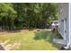 Grassy backyard featuring a dark privacy fence and natural landscaping at 1116 Sea Island Crossing Ln, Mount Pleasant, SC 29464