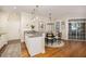 Dining area with updated kitchen, stylish chandelier, with sliding doors to back porch at 1116 Sea Island Crossing Ln, Mount Pleasant, SC 29464