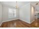 Open dining room with hardwood floors, bright window, and views to the kitchen at 1116 Sea Island Crossing Ln, Mount Pleasant, SC 29464