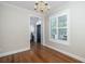 Well-lit dining room with wood floors, bright window, and modern lighting at 1116 Sea Island Crossing Ln, Mount Pleasant, SC 29464