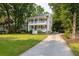 Charming two-story home with double porches, lush landscaping, and driveway at 1116 Sea Island Crossing Ln, Mount Pleasant, SC 29464