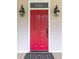 Close-up of the vibrant red front door with stylish lighting fixtures at 1116 Sea Island Crossing Ln, Mount Pleasant, SC 29464