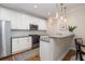 Updated kitchen with granite countertops, white cabinets, and stainless steel appliances, open to dining area at 1116 Sea Island Crossing Ln, Mount Pleasant, SC 29464