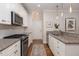 Modern kitchen with granite countertops, stainless steel appliances, and ample cabinet space and dining area at 1116 Sea Island Crossing Ln, Mount Pleasant, SC 29464
