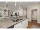 Granite countertops complement stainless sink and appliances in this bright, spacious kitchen at 1116 Sea Island Crossing Ln, Mount Pleasant, SC 29464