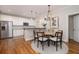 Well-equipped kitchen with stainless steel appliances and adjacent dining area featuring elegant lighting at 1116 Sea Island Crossing Ln, Mount Pleasant, SC 29464