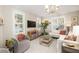 Bright living room with white walls, plantation shutters, and stylish decor and comfortable seating area at 1116 Sea Island Crossing Ln, Mount Pleasant, SC 29464