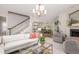 Open-concept living room with staircase, stylish decor and comfortable seating area, leading to dining area at 1116 Sea Island Crossing Ln, Mount Pleasant, SC 29464