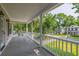 Large porch with white railing offers view of lawn and surrounding houses at 1116 Sea Island Crossing Ln, Mount Pleasant, SC 29464