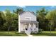 Charming two-story home with a welcoming front porch and lush landscaping, offering a picturesque curb appeal at 115 Battle Boat Blvd, Summerville, SC 29485