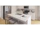 Modern kitchen features a center island with seating, stainless steel appliances, and plenty of counter space at 115 Lefton Lndg, Summerville, SC 29485