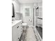 Bright bathroom with a modern vanity, patterned tile flooring and a glass enclosed shower at 116 Lyle Rd, Goose Creek, SC 29445
