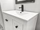 Bathroom vanity with a white countertop, sleek black faucet, and classic white cabinets with matte black hardware at 116 Lyle Rd, Goose Creek, SC 29445