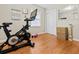 Versatile bedroom featuring an exercise bike, hardwood floors, and a sliding closet door at 116 Lyle Rd, Goose Creek, SC 29445