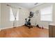 Versatile bedroom featuring an exercise bike, hardwood floors, and two windows offering natural light at 116 Lyle Rd, Goose Creek, SC 29445